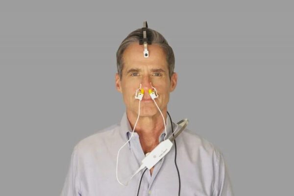 A man wearing a Vielight X-Plus 3 with a wire attached to it.