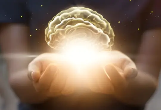 Glowing brain held in cupped hands.